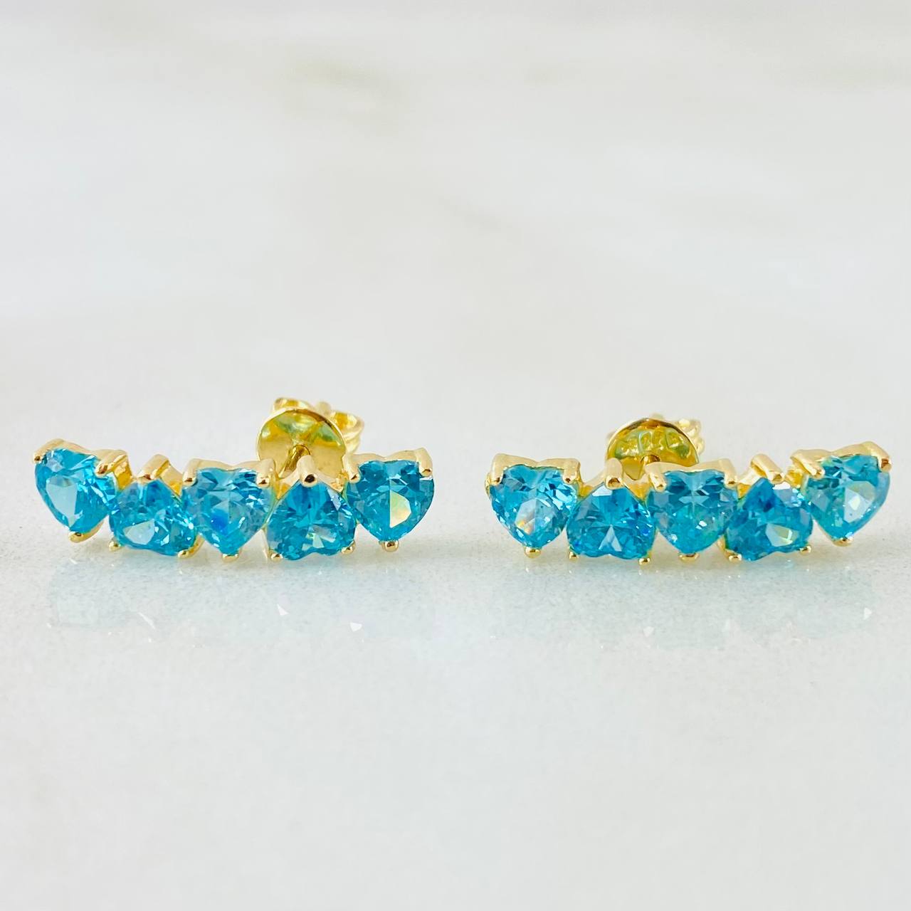 Topos Línea Corazones Celestes 2.7gr / Oro Amarillo 18K Topos Línea Corazones Celestes 2.7gr / Oro Amarillo 18K