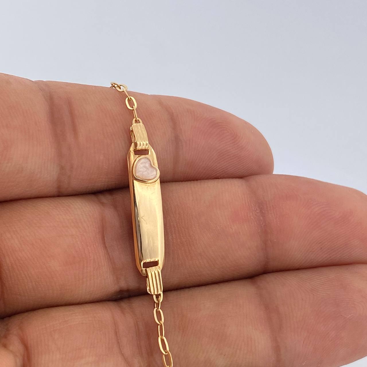 Pulso Bebe Cajon Corazon Rosado 1.5gr / 13.4cm-14.7cm / 1.8mm Placa Rectangular Curva Oro Amarillo 18K $ Pulso Bebe Cajon Corazon Rosado 1.5gr / 13.4cm-14.7cm / 1.8mm Placa Rectangular Curva Oro Amarillo 18K $