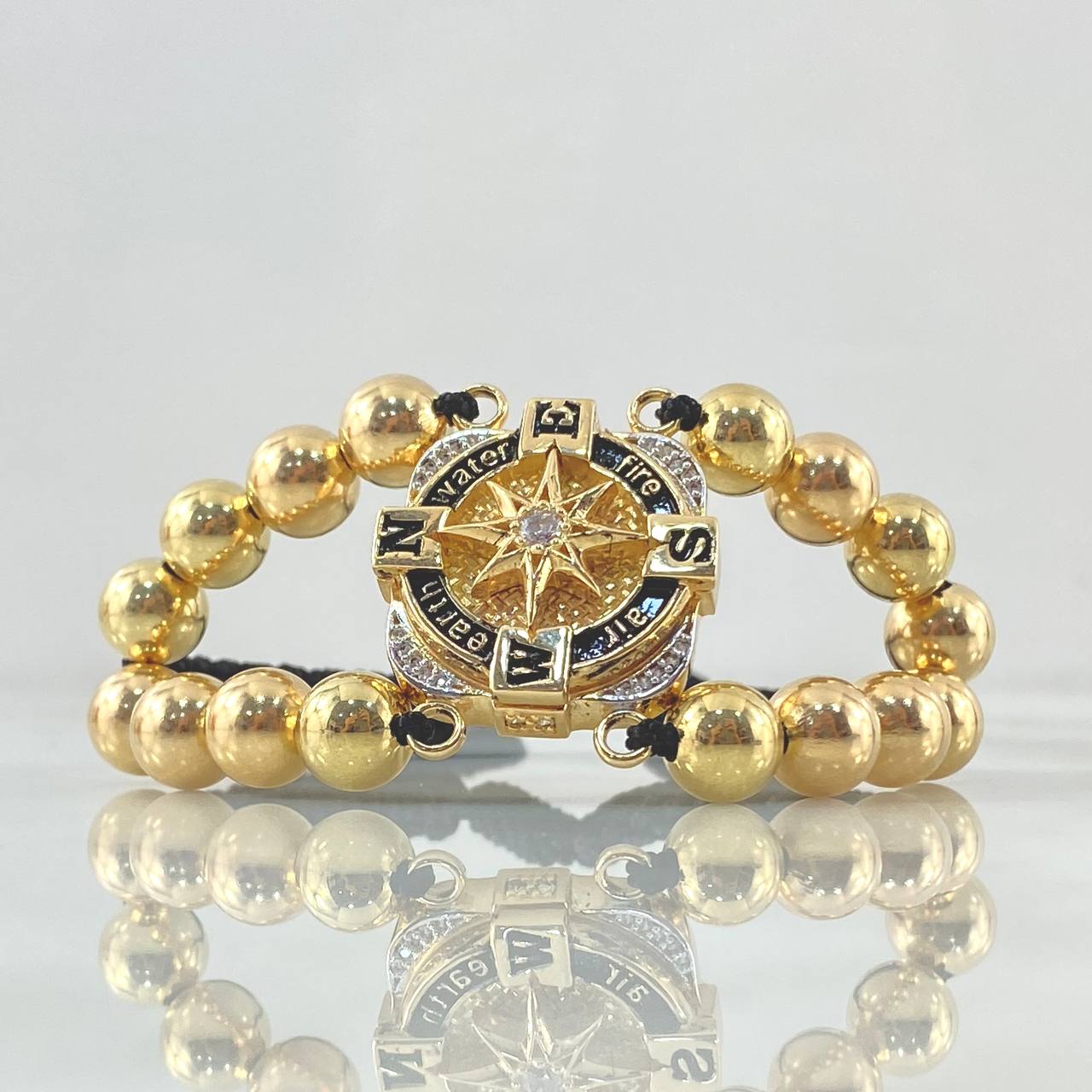 Pulsera Negra Brujula Elemental 17.1gr / 8mm Bolas Lisas 16 Und Oro Amarillo 18K © Pulsera Negra Brujula Elemental 17.1gr / 8mm Bolas Lisas 16 Und Oro Amarillo 18K ©