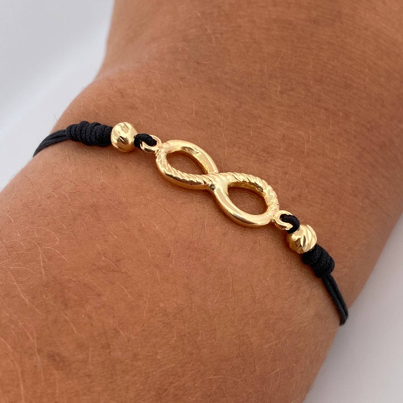 Pulsera Tejida Negra Infinito 1.3gr / Oro Amarillo 18K $ Pulsera Tejida Negra Infinito 1.3gr / Oro Amarillo 18K $
