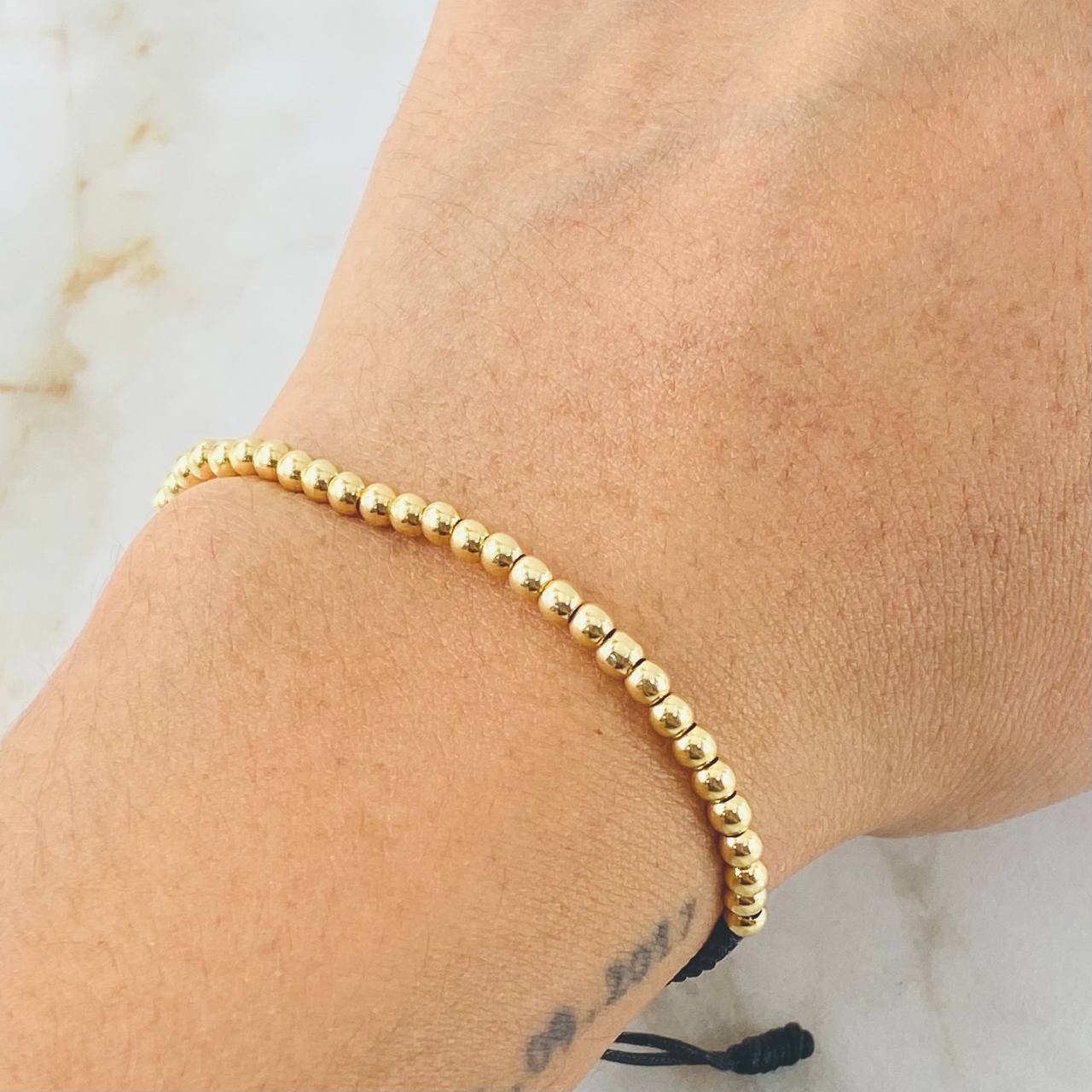 Pulsera Negra Bolas Lisas 1.5gr / Oro Amarillo 18K *