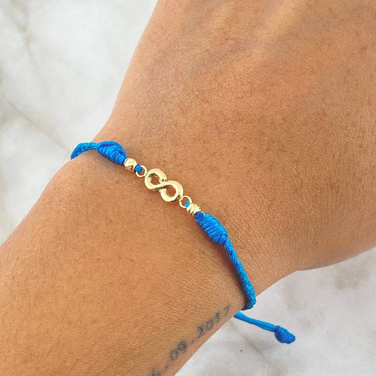 Pulsera Azul Infinito 0.55gr / 3mm Bolas Diamantadas 2 Und Oro Amarillo 18K *