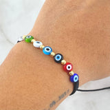 Pulsera Negra Ojo Turco 0.4gr / 3mm Bolas Diamantadas 6 Und Oro Amarillo 18K (A.C)
