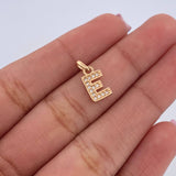 Dije Letra E 0.85gr / 1.4cm / Circones Blancos Oro Amarillo 18K $