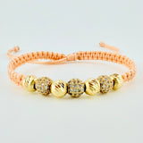 Pulsera Tejida Rosada Bolas Diamantadas Oro Amarillo 18K