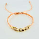 Pulsera Tejida Rosada Bolas Diamantadas Oro Amarillo 18K