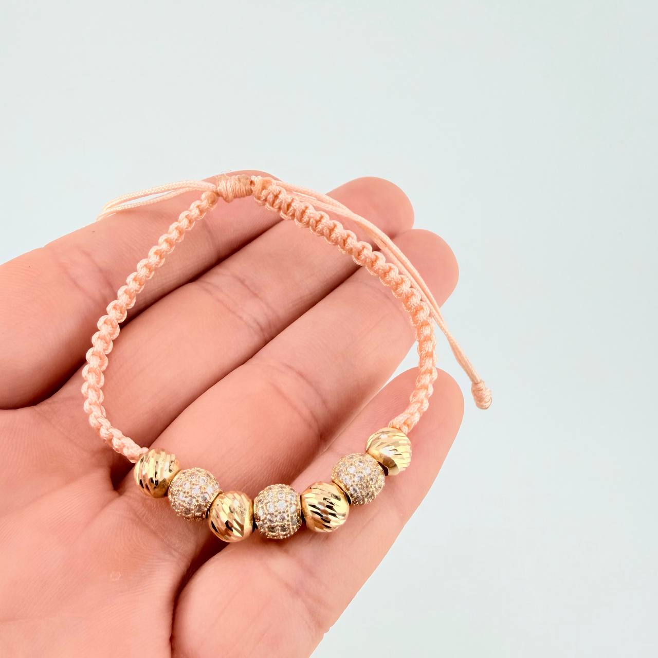 Pulsera Tejida Rosada Bolas Diamantadas Oro Amarillo 18K