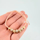 Pulsera Tejida Rosada Bolas Diamantadas Oro Amarillo 18K