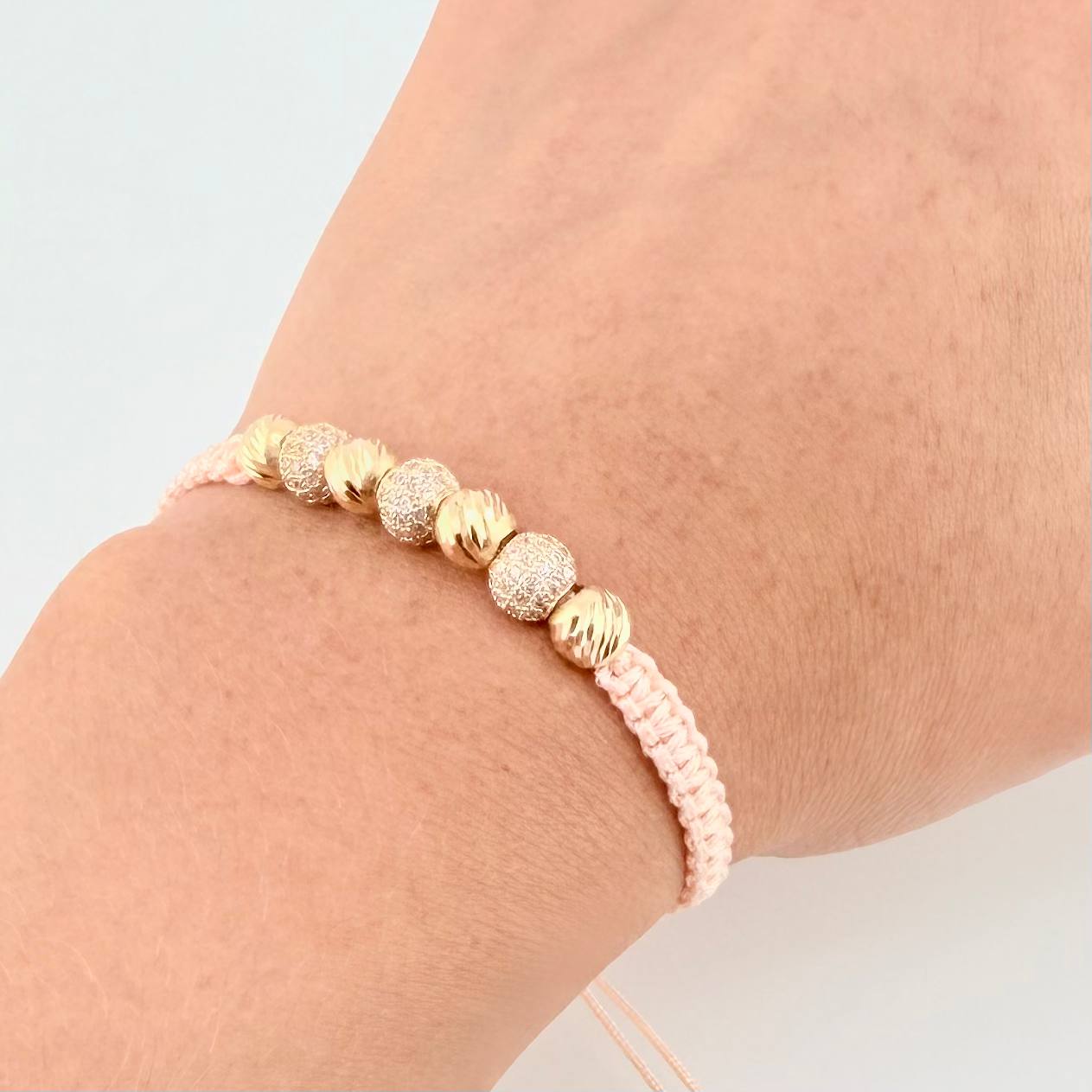 Pulsera Tejida Rosada Bolas Diamantadas Oro Amarillo 18K