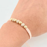 Pulsera Tejida Rosada Bolas Diamantadas Oro Amarillo 18K