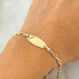 Pulso Bebé Placa Ovalada Huella Pie 1.95gr / 15cm / Oro Amarillo 18K