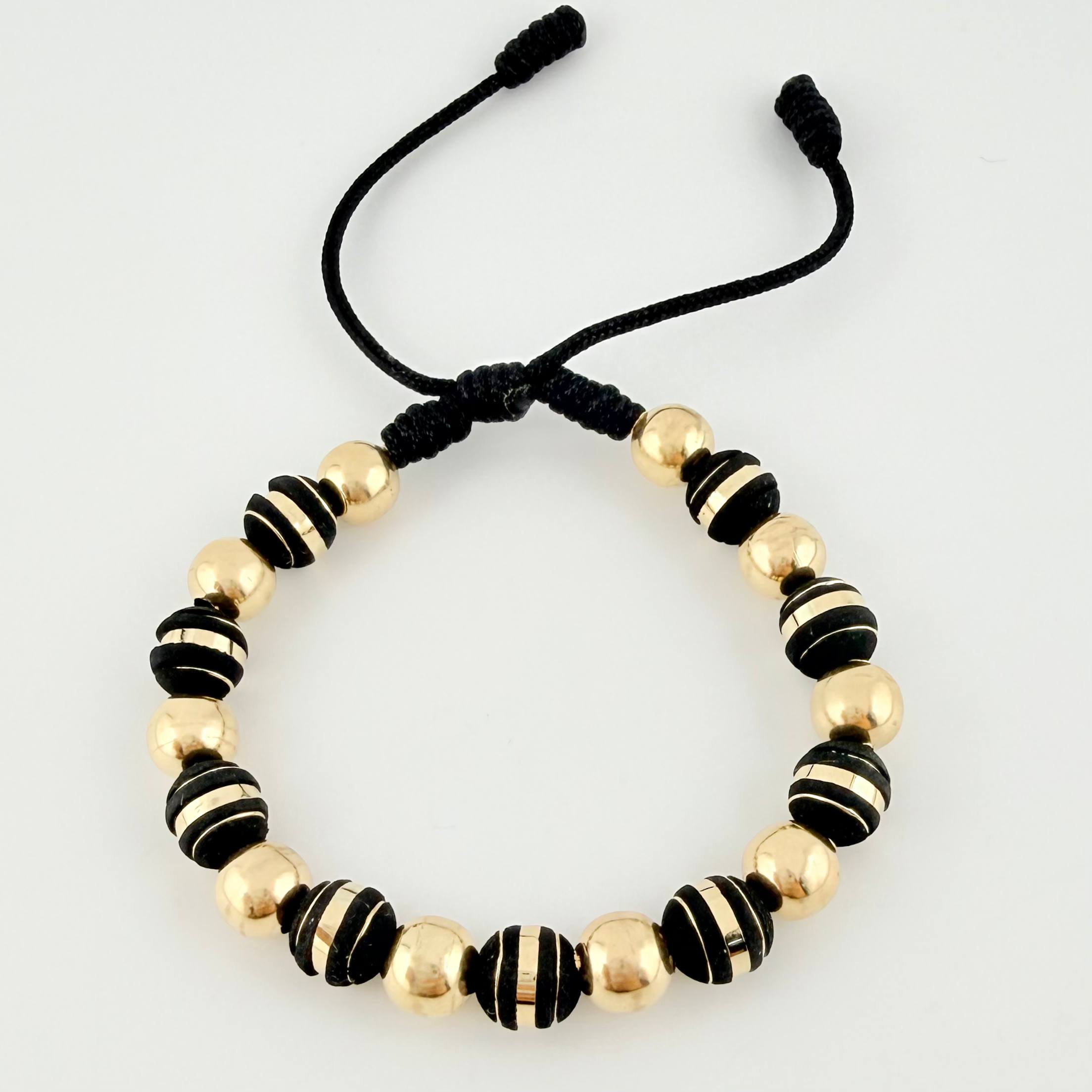 Pulsera Negra Neoros 9und Bolas 10und 2.5gr / 7mm Oro Amarillo 18K ©
