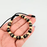 Pulsera Negra Neoros 9und Bolas 10und 2.5gr / 7mm Oro Amarillo 18K ©