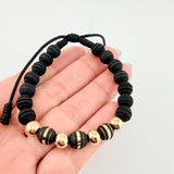 Pulsera Negra Neoros 3und Bolas 4und 1gr / 7mm Oro Amarillo 18K ©