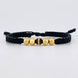 Pulsera Tejida Hilo Negro 4 Balines Lisos y Un Neoro Oro Amarillo 18K