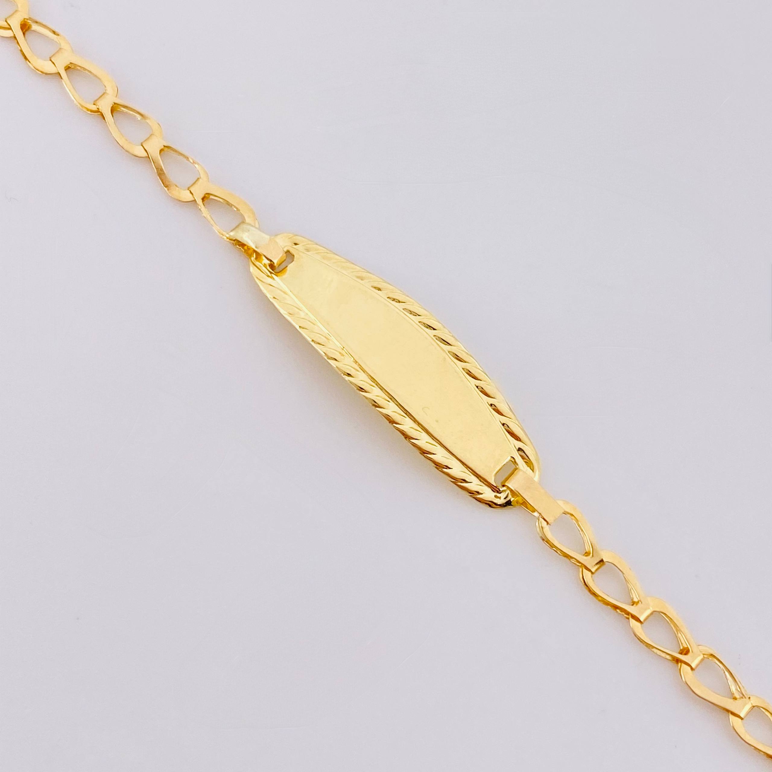 Pulso Bebé Espiga Placa Ovalada Bordeada 1.2gr / 14.5cm / 2.7mm Oro Amarillo 18K