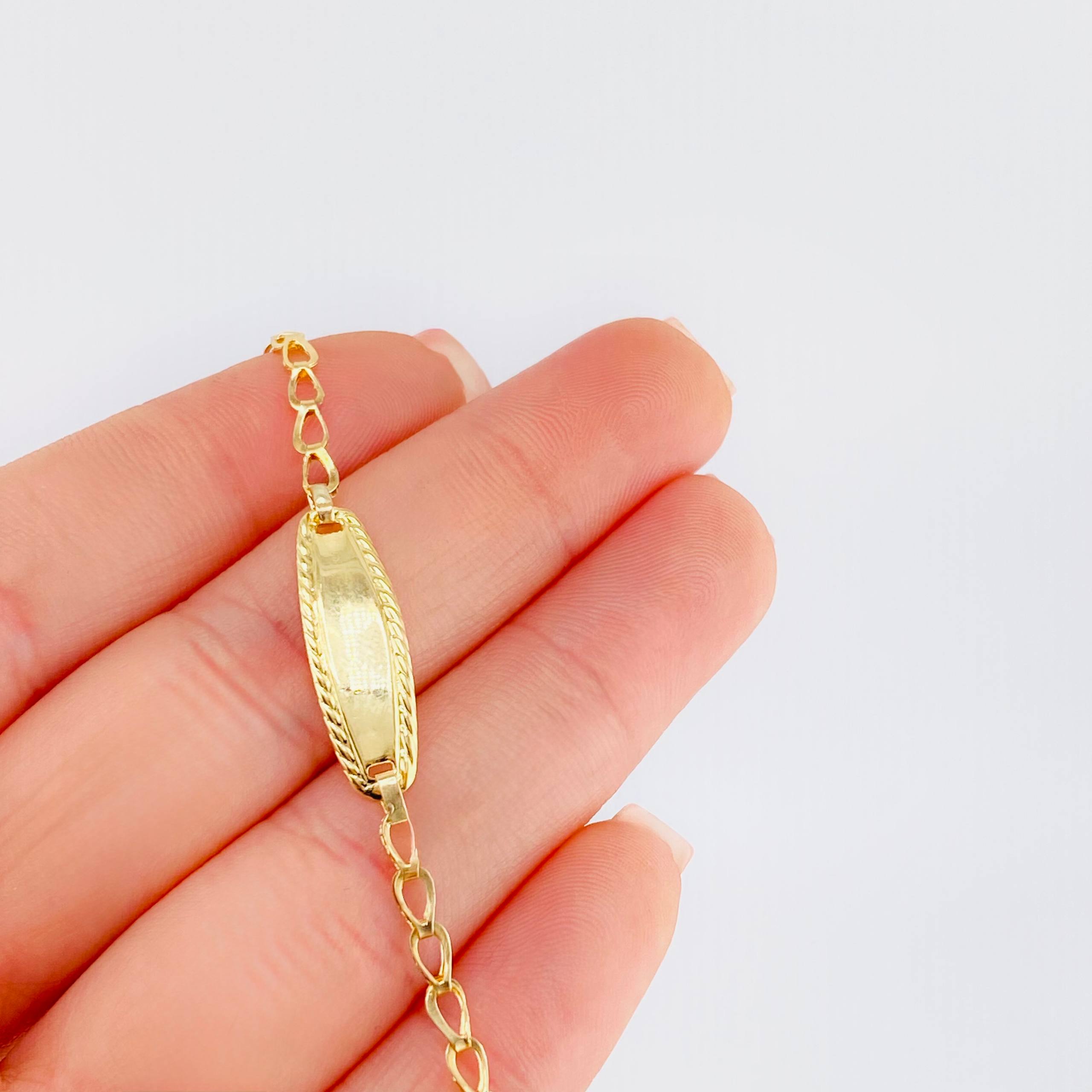 Pulso Bebé Espiga Placa Ovalada Bordeada 1.2gr / 14.5cm / 2.7mm Oro Amarillo 18K
