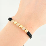 Pulsera Tejida Negra Bolas de Fuego Bolas Diamantadas Oro Amarillo 18K