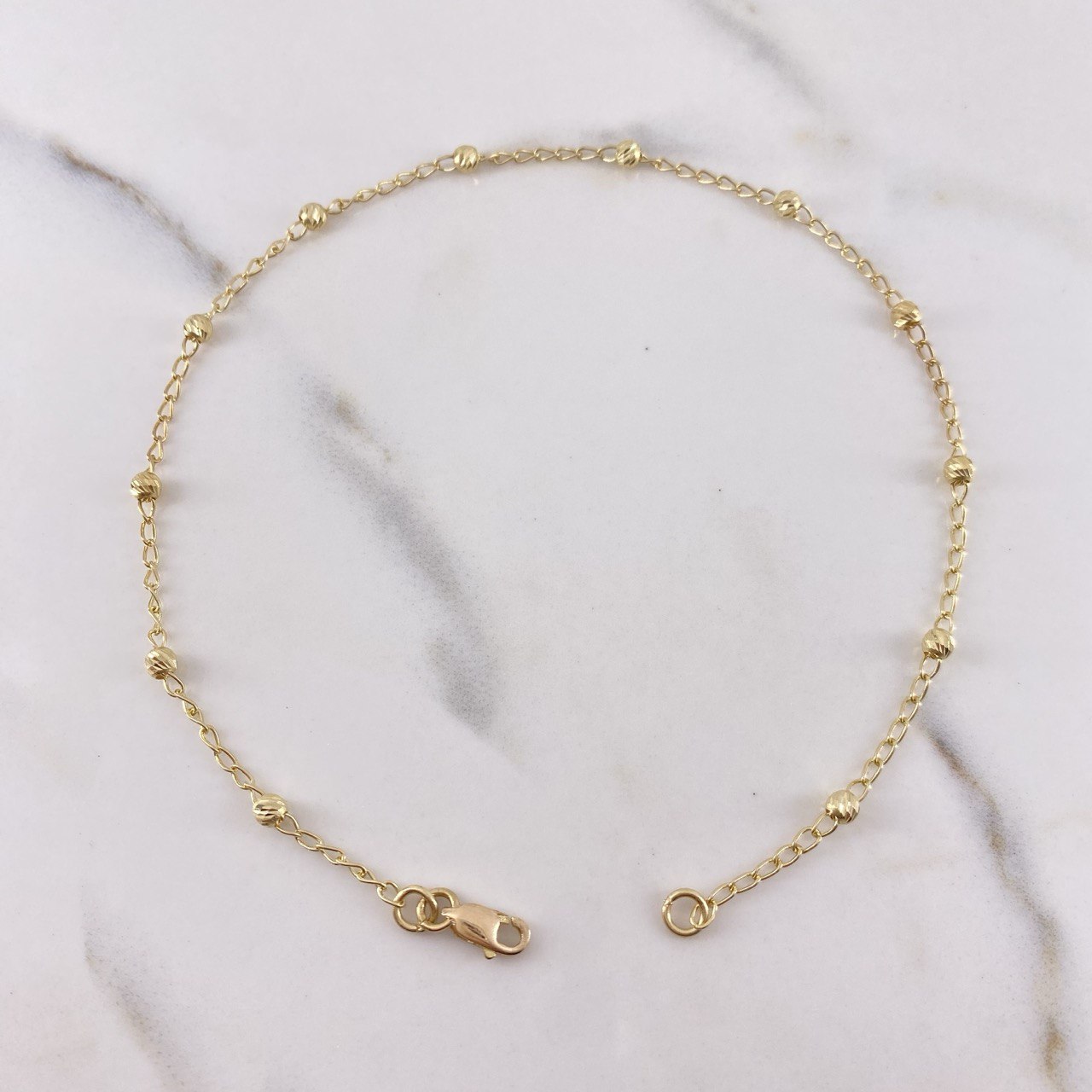 Tobillera Tipo Militar 2.25gr / 25cm / 2.8mm Bolas Diamantadas Oro Amarillo 18K $