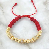 Pulsera Roja Dona Cilindros de Fuego 7.9gr / 7mm Bolas Diamantadas 12und Neoprenos Circones Blancos Oro Amarillo 18K ©
