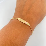 Pulso Bebe Aro Seguido 1.5gr / 13.6cm / 1mm Placa Rectangular Trebol rosado Oro Amarillo 18K $
