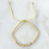 Pulsera Beige Herraje de San Benito 1.1gr / 3mm Bolas Diamantadas Tres Oros 18K