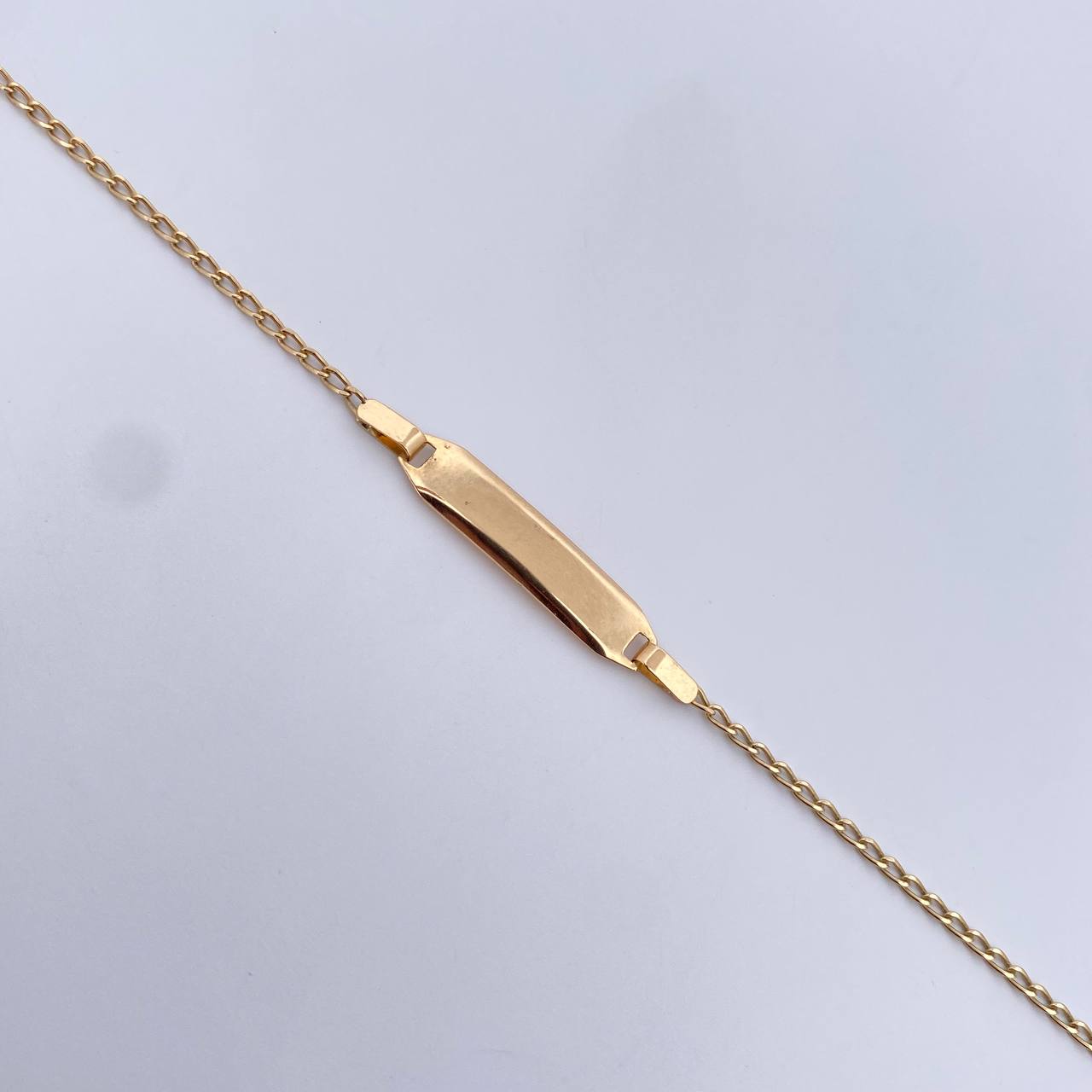 Pulso Bebe Espiga 1.25gr / 15.5cm / 1.2mm Placa Rectangular Ovalada Lisa Oro Amarillo +3 18K $