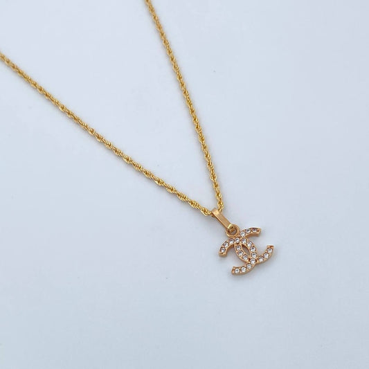 Set Cadena Lazo 1gr / 50cm / 1.1mm + Dije Ola Cruzada 0.5gr / 1.3cm Circones Blancos Oro Amarillo 18K (Oferta) $