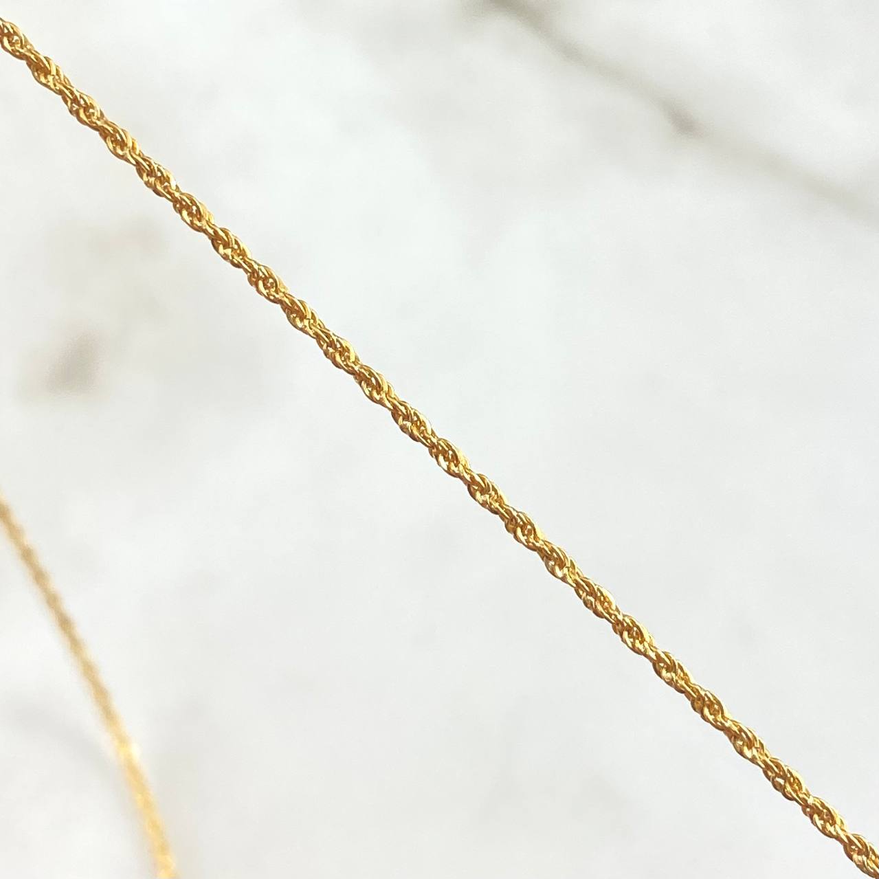 Set Cadena Lazo 1gr / 50cm / 1.2mm + Dije Ancla 0.45gr / 1.7cm Oro Amarillo 18K