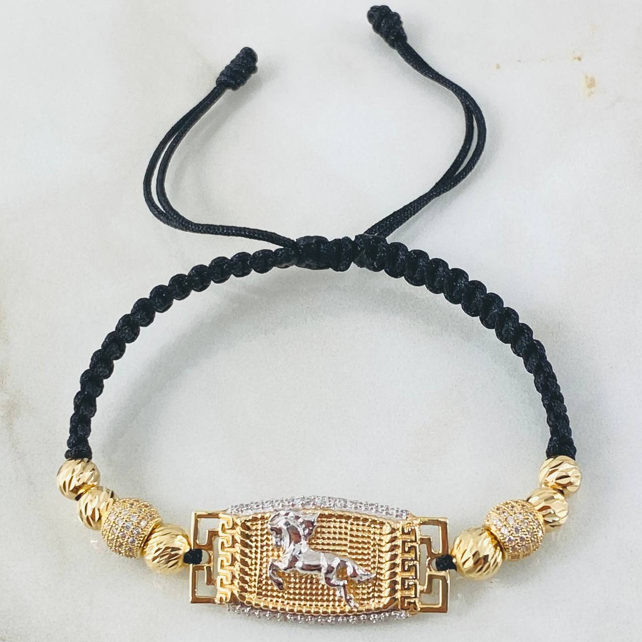 Pulsera Negra Herraje Caballo 6.45gr / Dos Oros Amarillo Blanco 18K ©