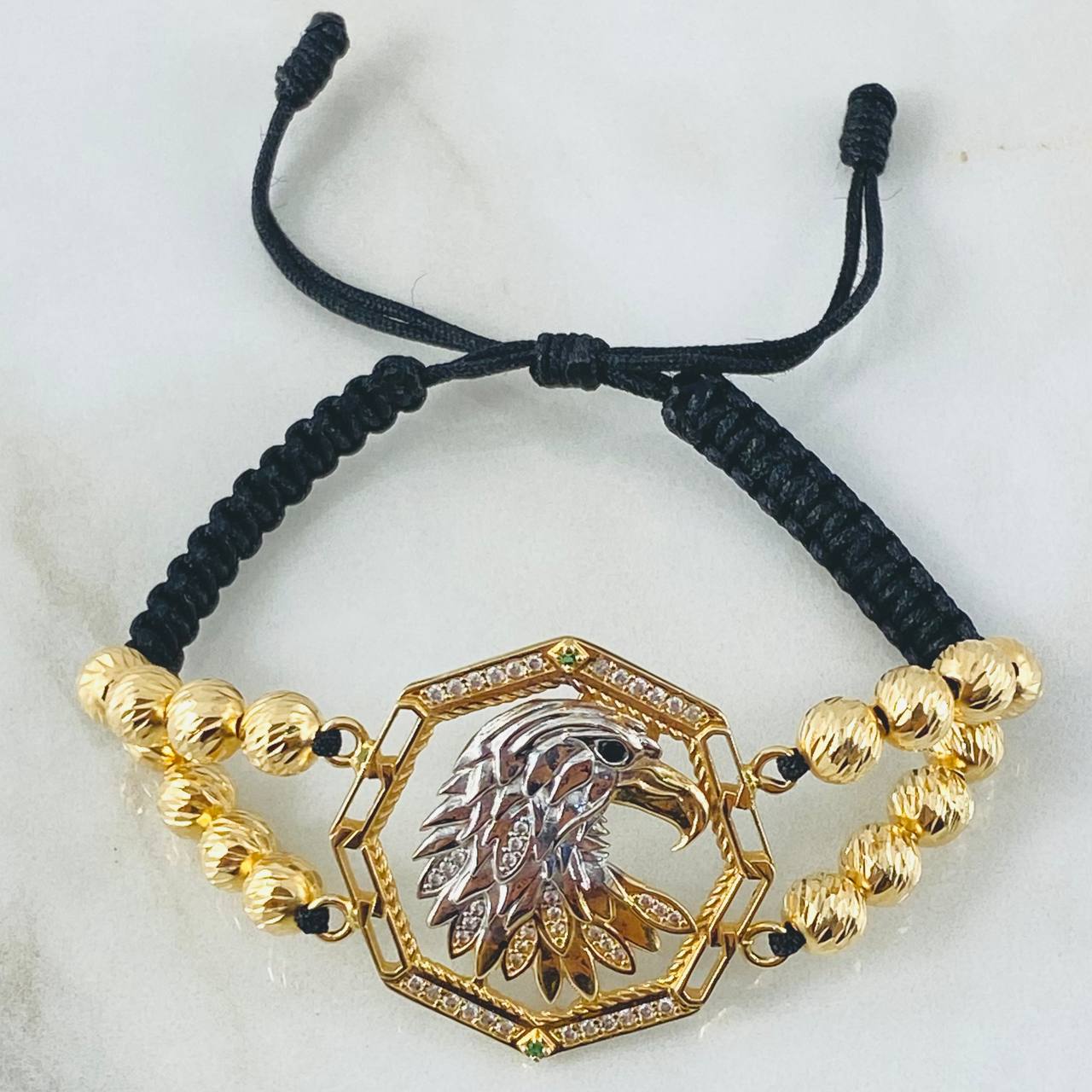 Pulsera Negra Herraje Aguila 13.1gr / Dos Oros Amarillo Blanco 18K ©