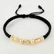 Pulsera Negra Cilindros Interceptos 7und / 4mm-5mm Oro Amarillo 18K *