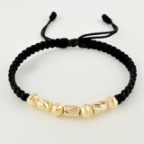 Pulsera Negra Cilindros Interceptos 7und / 4mm-5mm Oro Amarillo 18K *