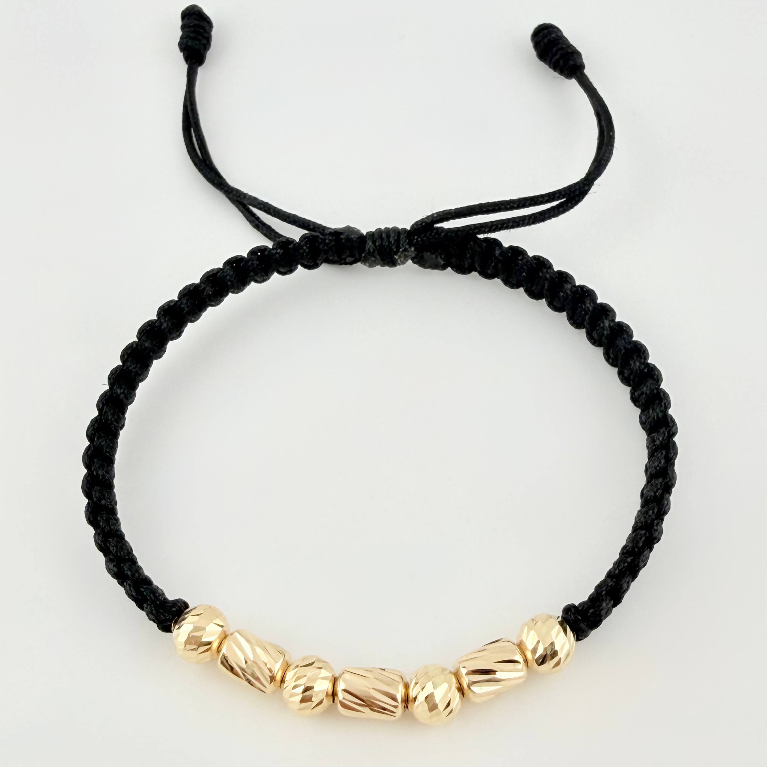 Pulsera Negra Cilindros Interceptos 7und / 4mm-5mm Oro Amarillo 18K *