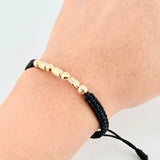 Pulsera Negra Cilindros Interceptos 7und / 4mm-5mm Oro Amarillo 18K *