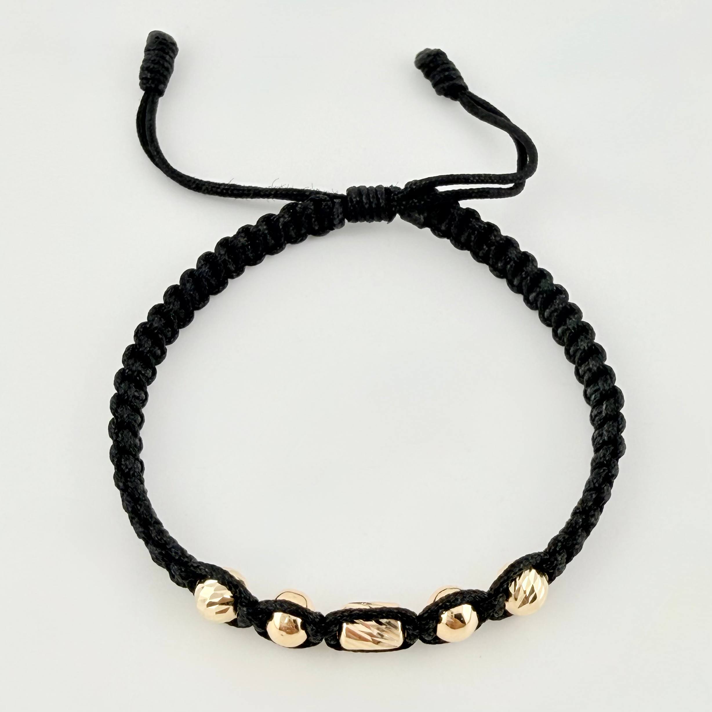 Pulsera Negra Cilindro Central 5und / 4mm-5mm Oro Amarillo 18K *