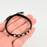 Pulsera Negra Cilindro Central 5und / 4mm-5mm Oro Amarillo 18K *