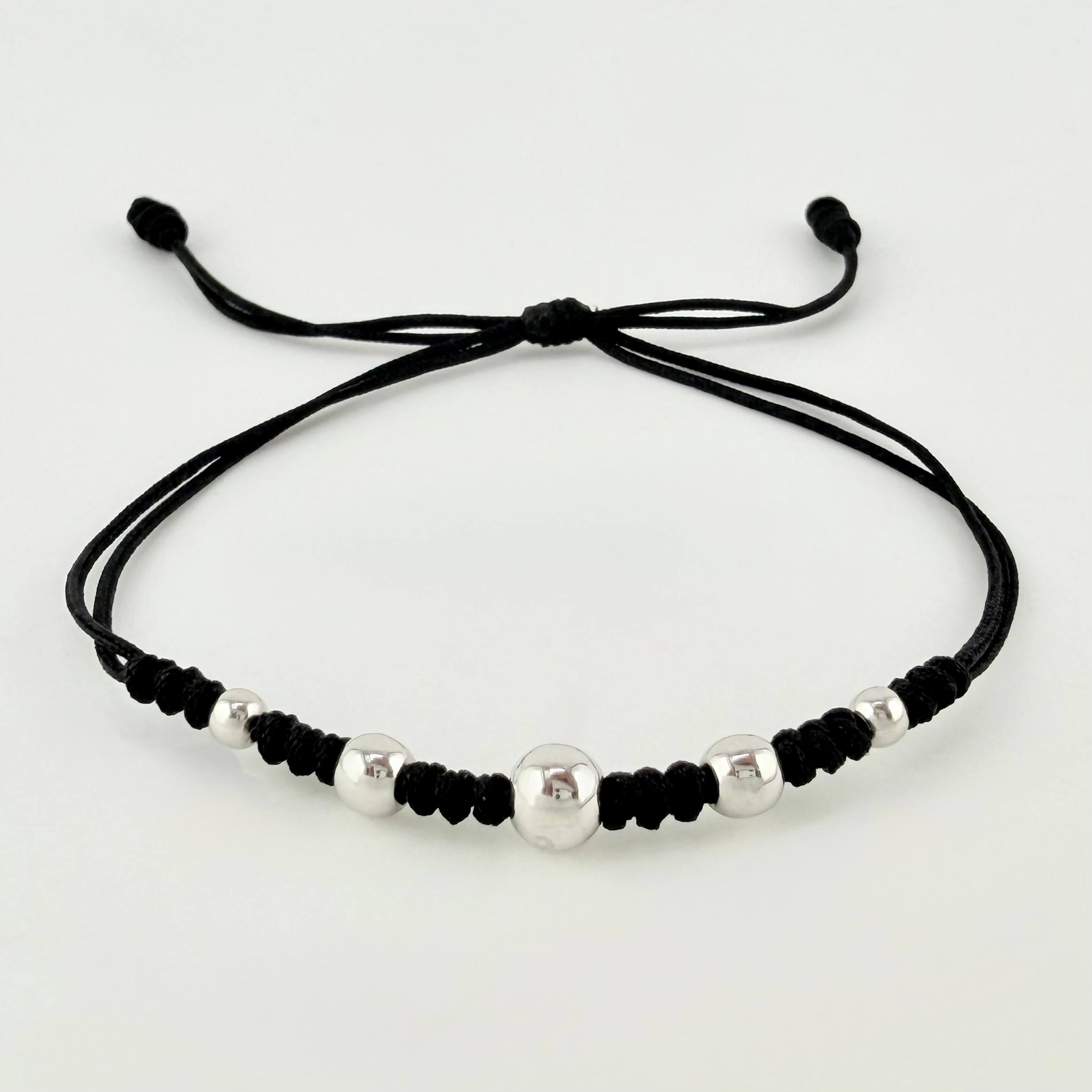 Pulsera Negra Secuencia Lisa 5und / 3mm-5mm Oro Blanco 18K *