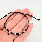 Pulsera Negra Secuencia Lisa 5und / 3mm-5mm Oro Blanco 18K *
