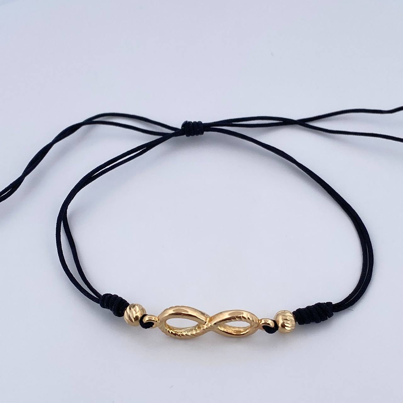 Pulsera Tejida Negra Infinito 1.3gr / Oro Amarillo 18K $