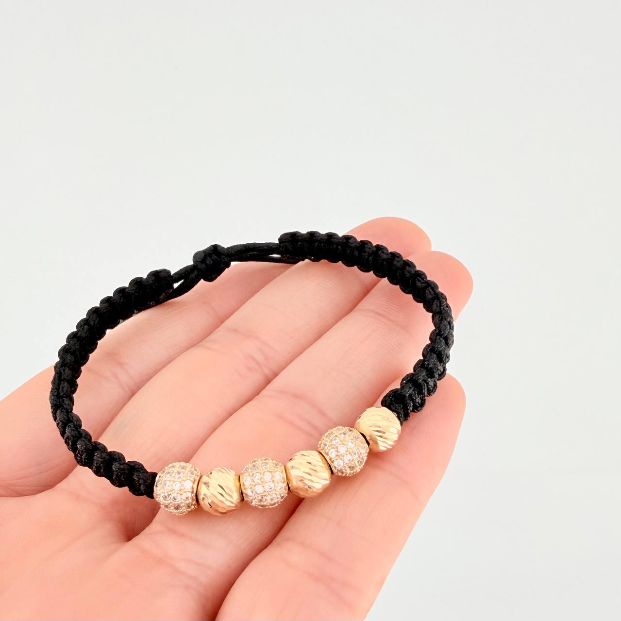 Pulsera Tejida Negra Bolas de Fuego Bolas Diamantadas Oro Amarillo 18K