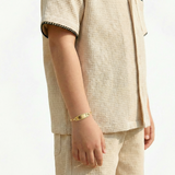 Pulso Bebé Espiga Placa Ovalada  Bordeada 1.2gr / 14.5cm / 2.7mm Oro Amarillo 18K ©