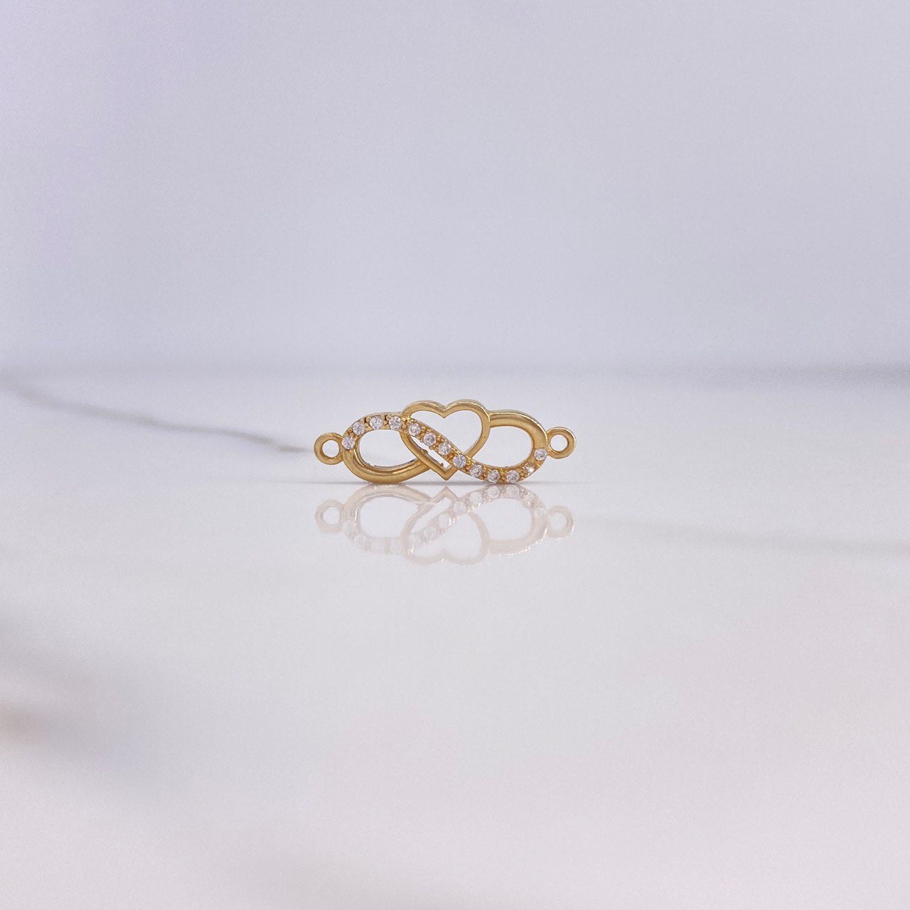 Herraje Infinito Corazón 0.75gr / 2cm / Circones Blancos Oro Amarillo $