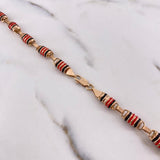 Cadena Rustica Rayada 21.25gr / 65cm / 6mm Barril Cauchos Negros-Rojos Oro Rosa $
