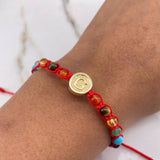 Pulsera Roja Herraje Letra G 0.55gr / 1cm / 4mm Tambor 7 Chakras Oro Amarillo $