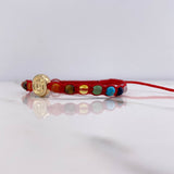 Pulsera Roja Herraje Letra G 0.55gr / 1cm / 4mm Tambor 7 Chakras Oro Amarillo $