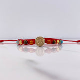Pulsera Roja Herraje Letra G 0.55gr / 1cm / 4mm Tambor 7 Chakras Oro Amarillo $