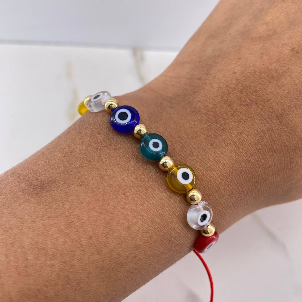 Pulsera Roja Ojos Turcos 0.85gr / 4mm Bolas Lisas Oro Amarillo $