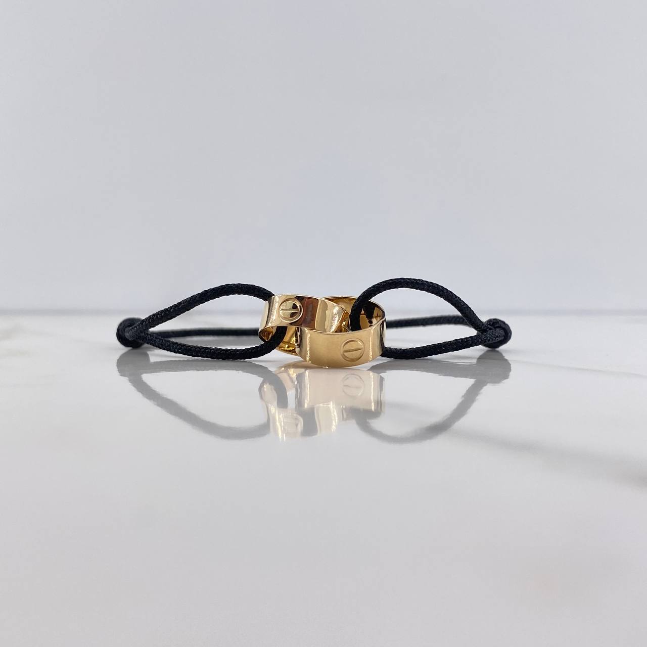 Pulsera Negra Argollas Tornillo 3.1gr / Lisas Oro Amarillo $