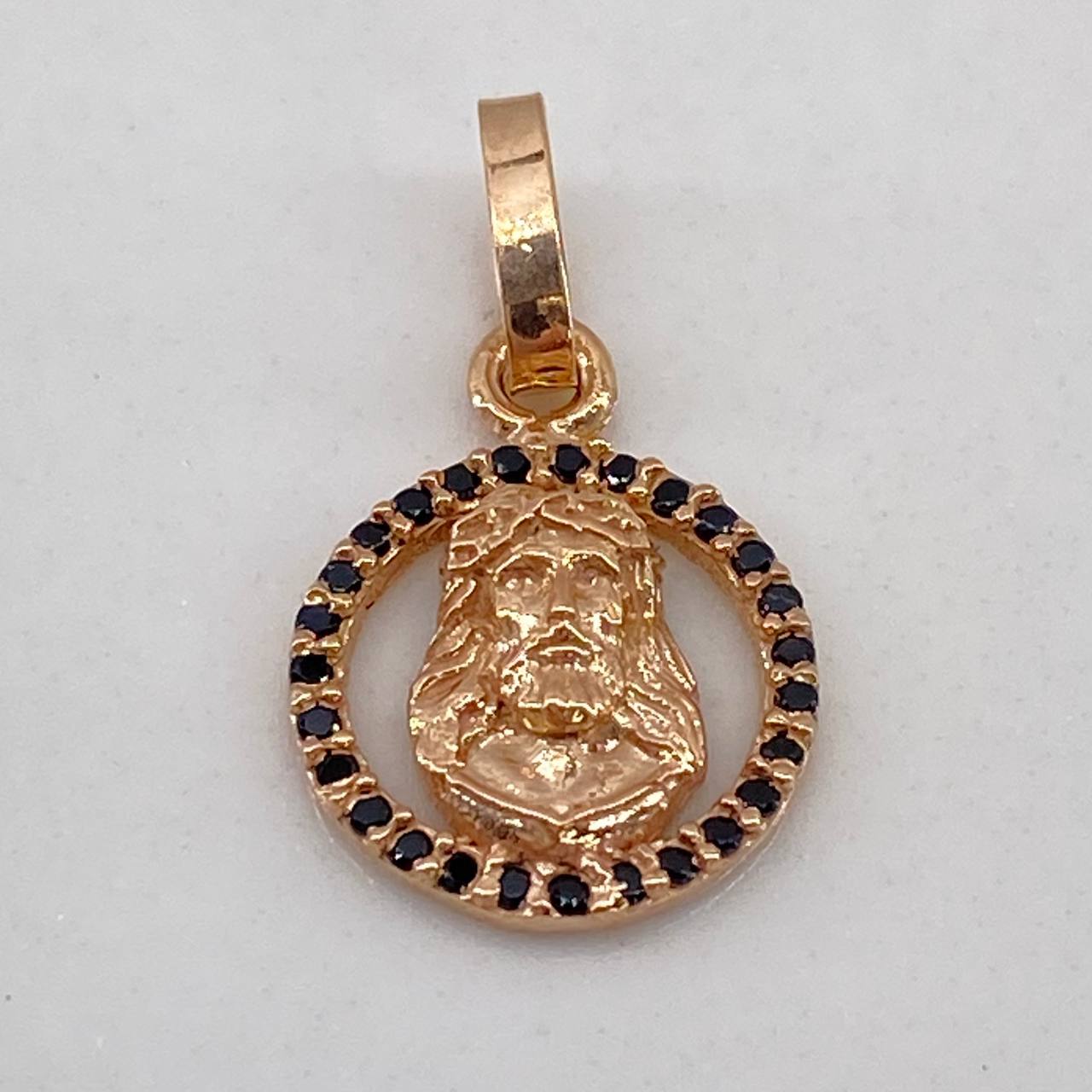 Dije Rostro de Cristo 0.65gr / 1.5cm / Circones Negros Oro Rosa$